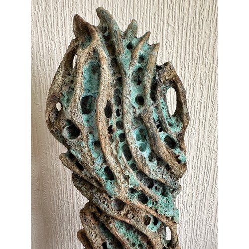 331 - Wendy Lawrence; a carved stoneware sculpture layered with textured volcanic glazes on a stone base, ... 