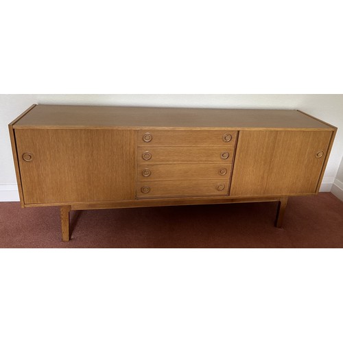 111 - A Mid Century Scandinavian style sideboard with four central drawers, the top one fitted with three ... 