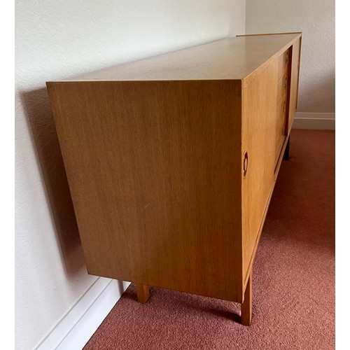 111 - A Mid Century Scandinavian style sideboard with four central drawers, the top one fitted with three ... 