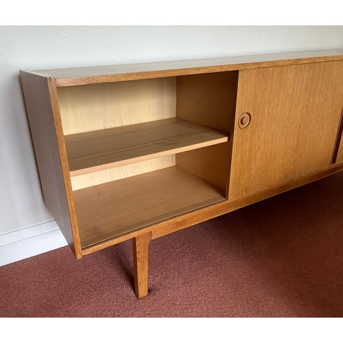 111 - A Mid Century Scandinavian style sideboard with four central drawers, the top one fitted with three ... 