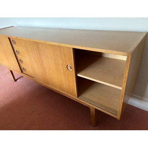 111 - A Mid Century Scandinavian style sideboard with four central drawers, the top one fitted with three ... 