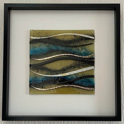 414 - A Lisa Villarospo fused glass piece of wall art depicting waves in a deep black frame 52 x 52cm.