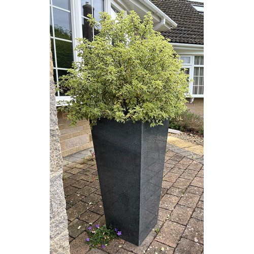 11 - A grey granite taper pillar planter 85cm h. Comes with compost and plant.