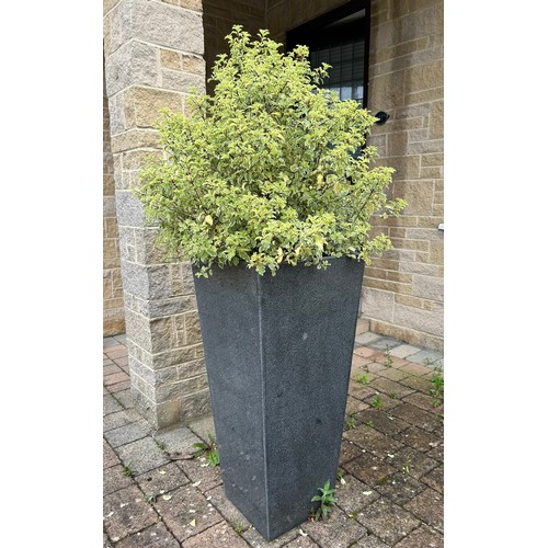 11 - A grey granite taper pillar planter 85cm h. Comes with compost and plant.