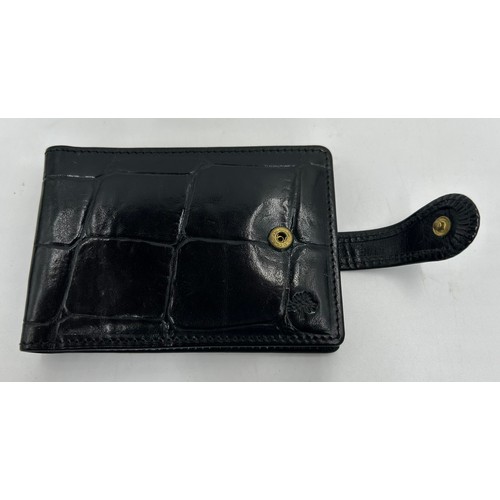 902 - A Mulberry Leather Wallet in black reptile print with zipped coin purse and three note compartments,... 