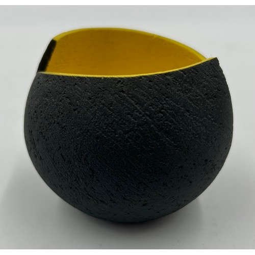 283 - A contemporary Ashraf Hanna small textured earthenware vessel with charcoal exterior and yellow inte... 