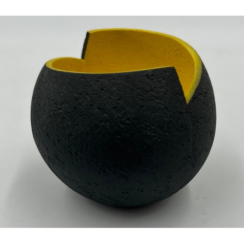 283 - A contemporary Ashraf Hanna small textured earthenware vessel with charcoal exterior and yellow inte... 