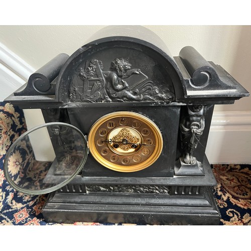 998 - A 19thC slate mantel clock with decorative panel to top and two caryatids to either side of brass di... 