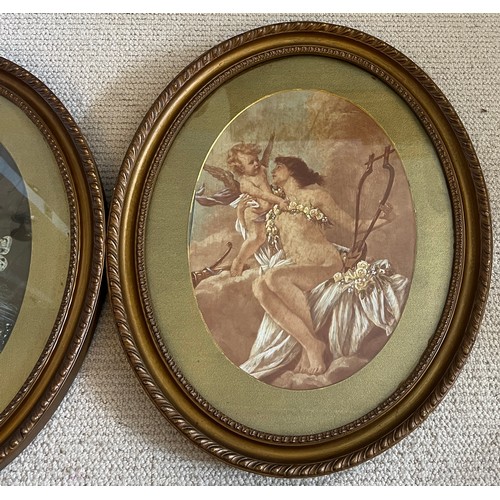 1370 - A pair of oval gilt framed prints of scantily clad females with cherubs. Print size 35cm x 25cm.