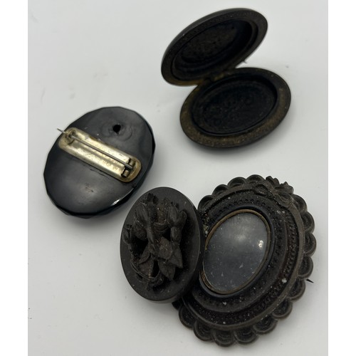 569 - Two 19thC brooches to include jet with carved cameo of female head and an opening photograph frame. ... 