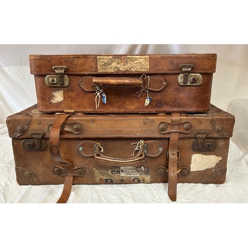 1257 - A pair of 1930's vintage suitcases with original world wide travel labels largest to measure 70cm x4... 