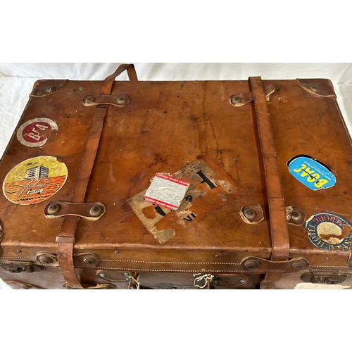 1257 - A pair of 1930's vintage suitcases with original world wide travel labels largest to measure 70cm x4... 