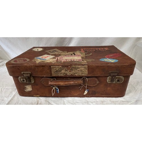 1257 - A pair of 1930's vintage suitcases with original world wide travel labels largest to measure 70cm x4... 