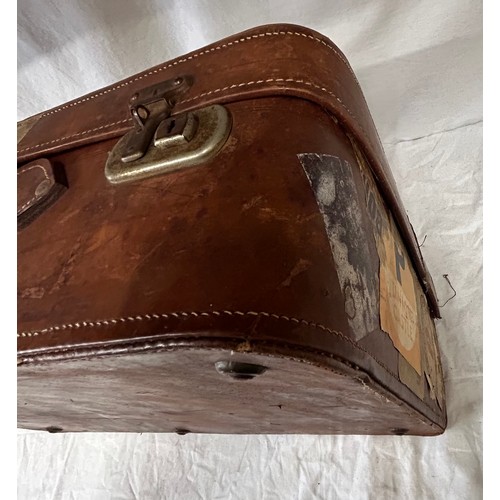 1257 - A pair of 1930's vintage suitcases with original world wide travel labels largest to measure 70cm x4... 