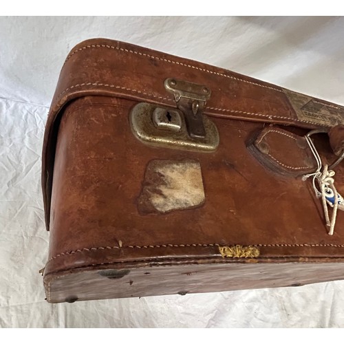 1257 - A pair of 1930's vintage suitcases with original world wide travel labels largest to measure 70cm x4... 