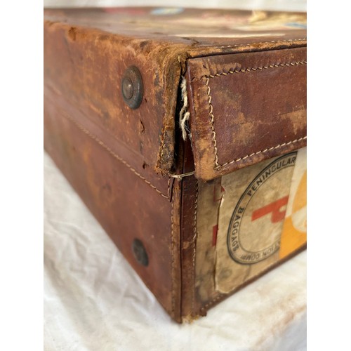 1257 - A pair of 1930's vintage suitcases with original world wide travel labels largest to measure 70cm x4... 