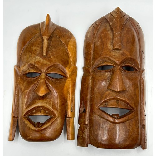 929 - A collection of six hand carved wooden wall plaques along with two tribal wooden hand carved wooden ... 