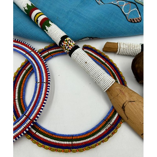 931 - Traditional African tribal pieces to include Maasai beaded necklaces, a beaded dance stick, water ca... 