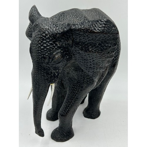 927 - A collection of carved wooden figures to include an elephant, Rhinoceros, crocodile, Swordfish, gaze... 