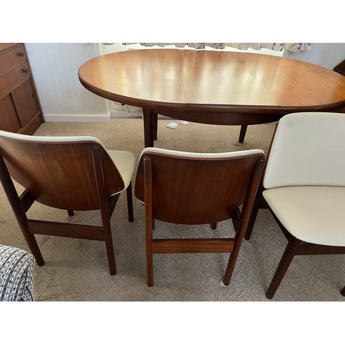 101 - A mid 20thC Eon teak extending dining table and four chairs. 163cm x 121cm extended. Leaf 42cm w.