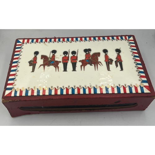 1259 - A leather covered giant match box with enamelled top depicting soldiers and horses. 22cm x 13cm x 5c... 