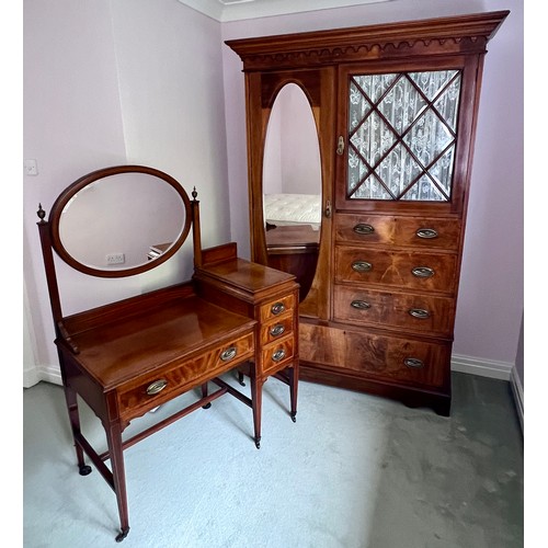 77 - An Edwardian mahogany inlaid wardrobe and dressing table. The wardrobe with single door, 3 short dra... 