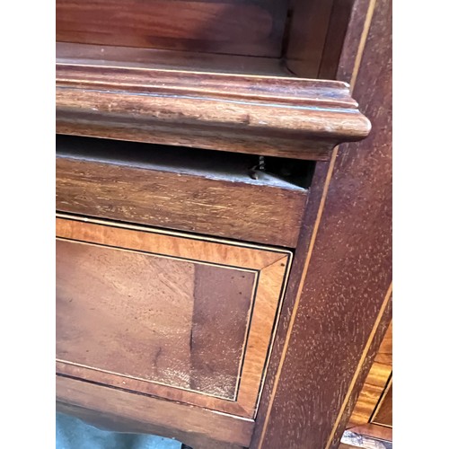 77 - An Edwardian mahogany inlaid wardrobe and dressing table. The wardrobe with single door, 3 short dra... 