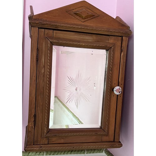 79 - A pine wall mounted cabinet with mirrored door and interior shelf. 53cm h x 27cm d x 36cm w.