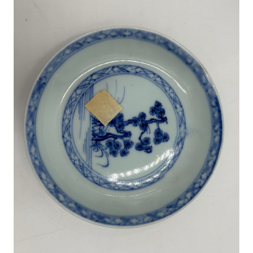 256 - A 18thC Nanking Cargo tea bowl 4cm h and saucer 11.7cm d  with underglaze blue painted decoration of... 