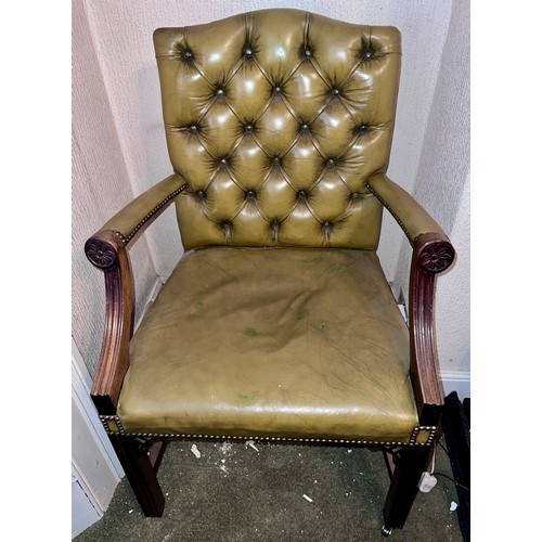 74 - A leather covered mahogany framed armchair on castors.