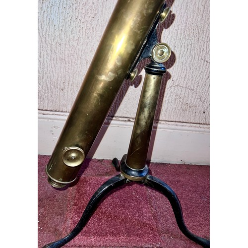 1264 - A brass telescope on cast iron stand.