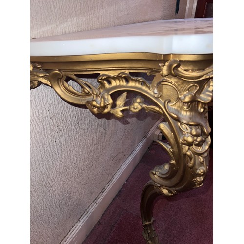 95 - A gilt plaster console table with white marble door. 87 h x 84 w x 39cm h.