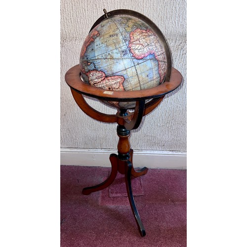 93 - A 20thC terrestrial globe on wooden stand. 97cm h.