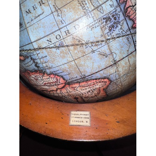 93 - A 20thC terrestrial globe on wooden stand. 97cm h.