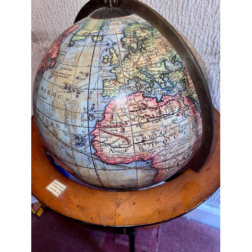 93 - A 20thC terrestrial globe on wooden stand. 97cm h.