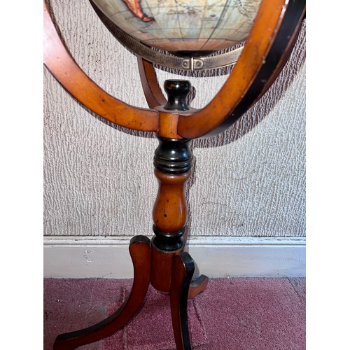 93 - A 20thC terrestrial globe on wooden stand. 97cm h.