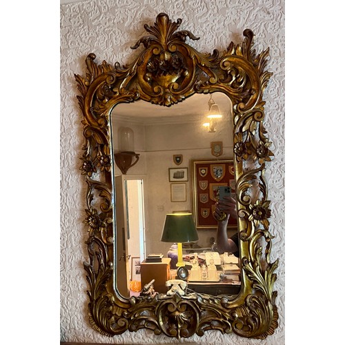 1239 - A 20thC gilt decorative framed wall mirror.  102 x 62cm w.