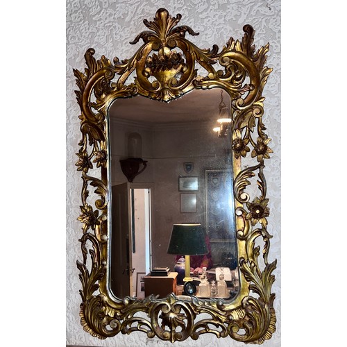 1239 - A 20thC gilt decorative framed wall mirror.  102 x 62cm w.