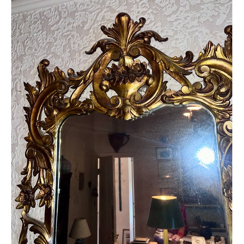 1239 - A 20thC gilt decorative framed wall mirror.  102 x 62cm w.