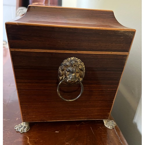 947 - A good quality mahogany and inlaid tea caddy with ivory escutcheon and lions paw feet with lion mask... 