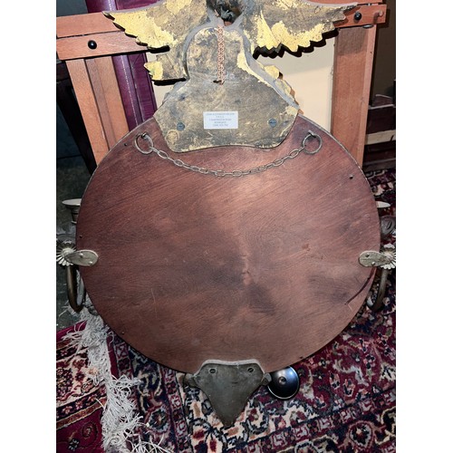 1238 - A circular convex wall mirror with eagle top and later additions. 59cm w x 66cm h.