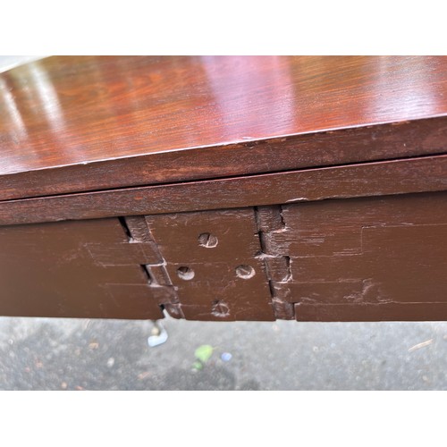 70 - A Gillows mahogany fold over tea table on reeded legs with brass castors. 91cm w x 45cm d x 75cm h. ... 