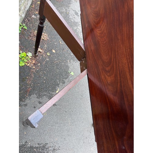 70 - A Gillows mahogany fold over tea table on reeded legs with brass castors. 91cm w x 45cm d x 75cm h. ... 