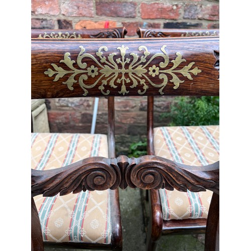 71 - Four Regency rosewood sabre legged dining chairs with brass inlay to back and drop in seats.