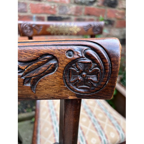 71 - Four Regency rosewood sabre legged dining chairs with brass inlay to back and drop in seats.