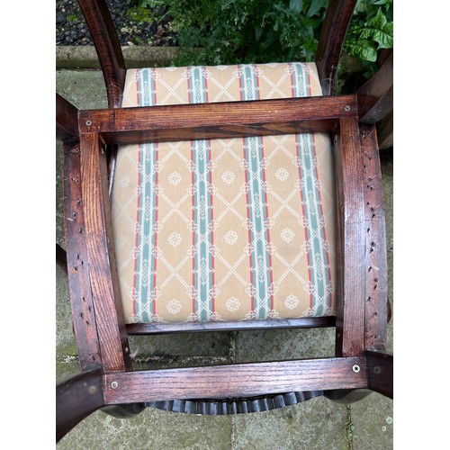 71 - Four Regency rosewood sabre legged dining chairs with brass inlay to back and drop in seats.