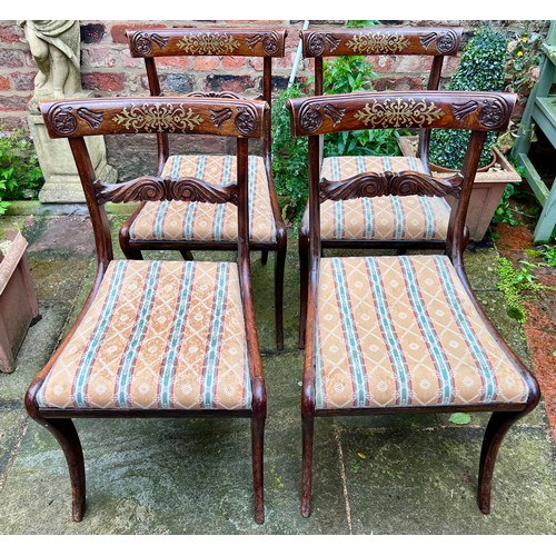 71 - Four Regency rosewood sabre legged dining chairs with brass inlay to back and drop in seats.