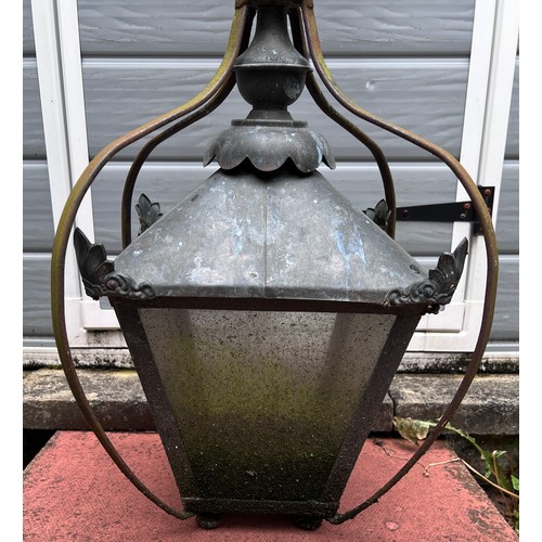 1024 - A wall mounted metal outdoor lamp on bracket. 100cm h from bracket.