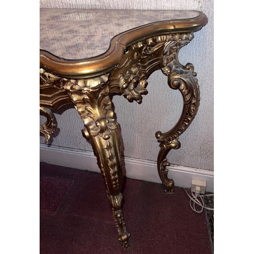 69 - A decorative gilt console table with mirrored top 138cm w x 48cm d x 80cm h.