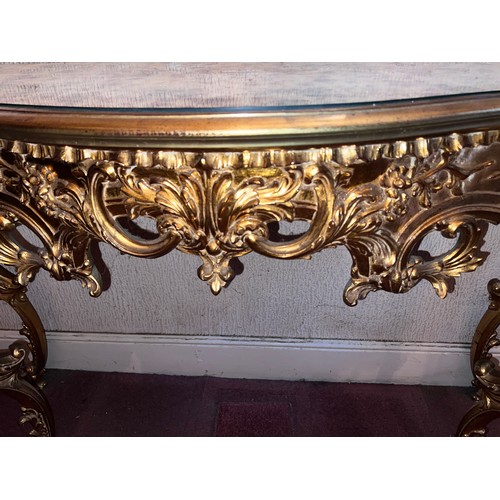 69 - A decorative gilt console table with mirrored top 138cm w x 48cm d x 80cm h.